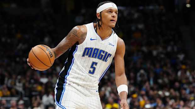 Magic forward dribbles the ball in a game.